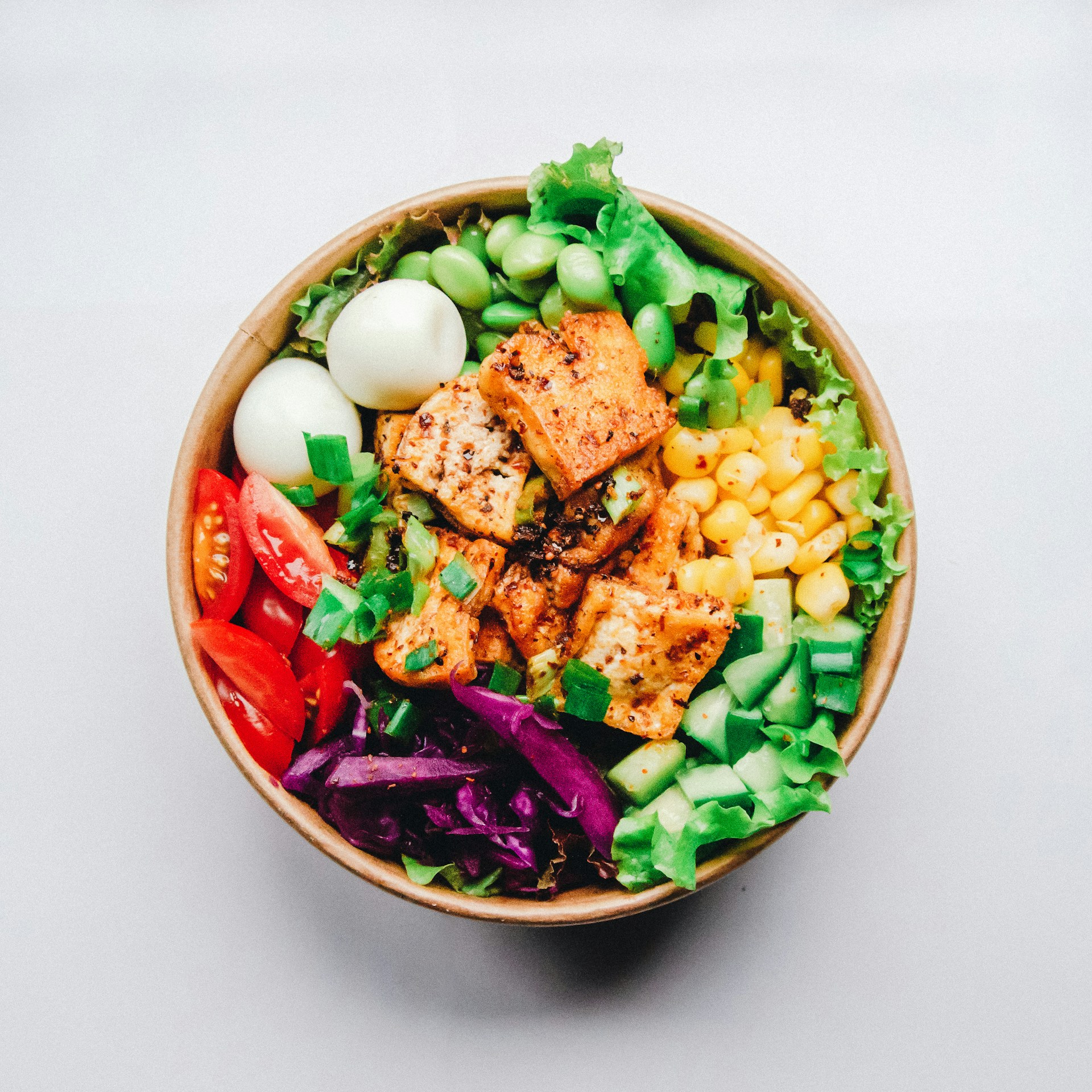 Meat, boiled eggs and vegetables in a bowl